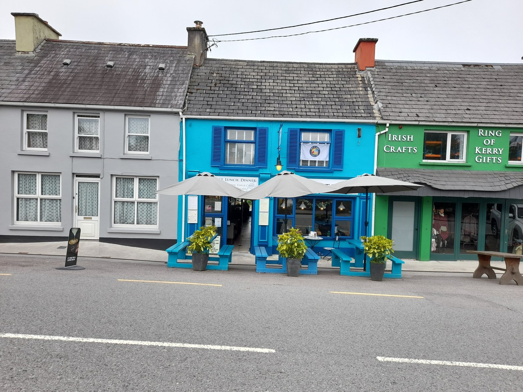 Adam's Kitchen's newly repainted turquoise-blue storefront in the middle of Sneem village, Co. Kerry